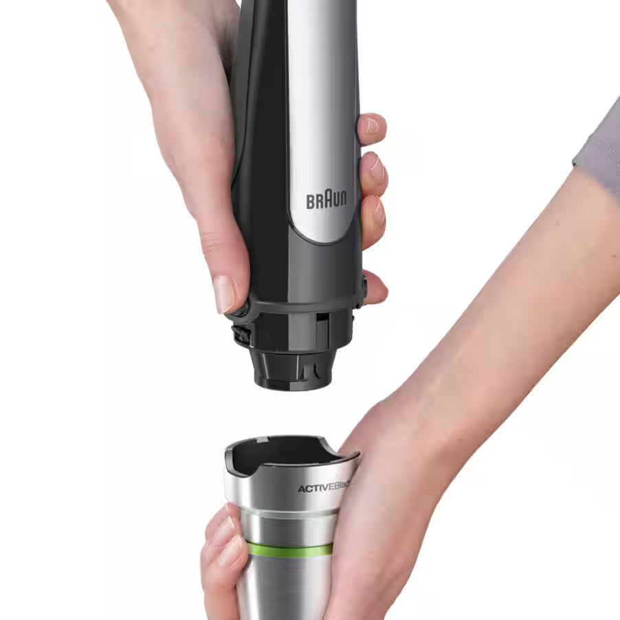 Braun electric shaver held by a person with a white background