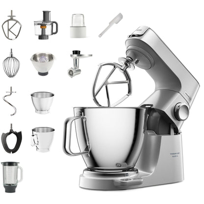 Kitchen stand mixer with various attachments on a white background