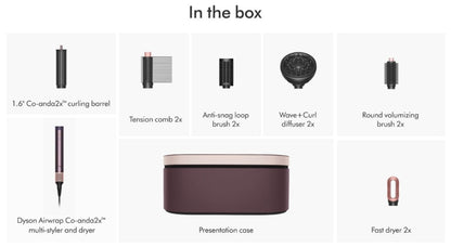 In the box layout showing included styling tools and accessories: two curling barrels, two tension combs, two anti-snag loop brushes, two wave and curl diffusers, two round volumizing brushes, a presentation case, and a fast dryer, with a Dyson Airwrap Co-anda2 multi-styler and dryer pictured.