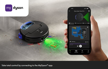 A Dyson robot vacuum cleaner is shown on a gray tiled floor, emitting a green laser light, while a human hand holds a smartphone displaying the MyDyson app. The MyDyson logo is visible in the top left corner.