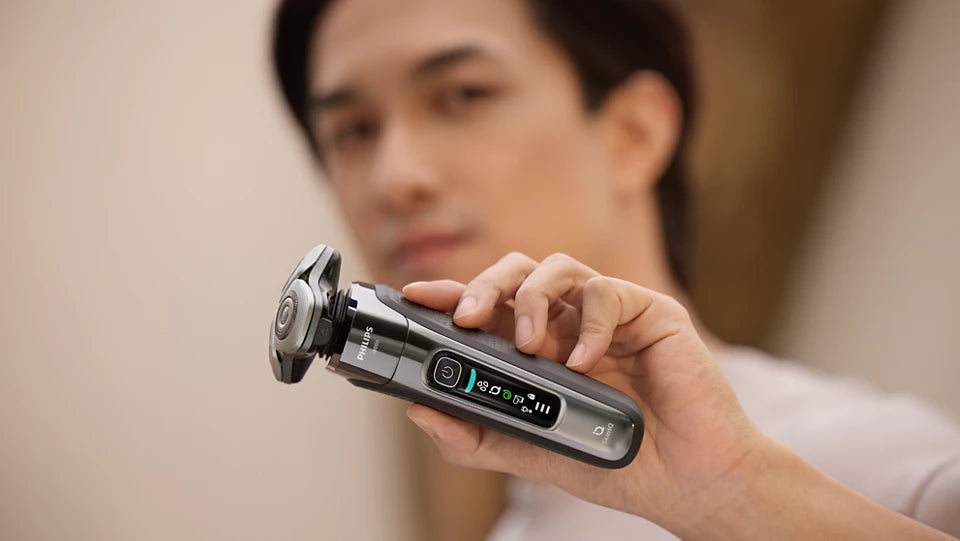 Person holding a grooming tool with a blurred background