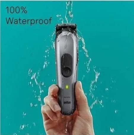 Taghareed Braun All-in-One Style Kit Series 7 MGK7420, silver waterproof trimmer with green indicator light being rinsed under water.