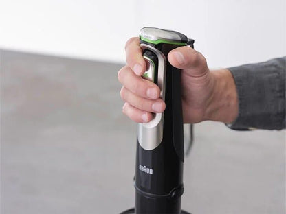 Taghareed Braun MultiQuick 9 hand blender in black with silver accents and green trim, held by a hand.