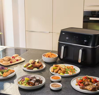 Taghareed Braun TwinCook 5 TD5030IBK black dual-basket air fryer with various meals