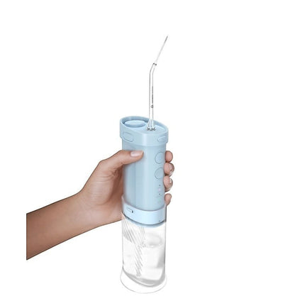 Taghareed light blue cordless water flosser with 3 modes and 200ml tank, held in hand.