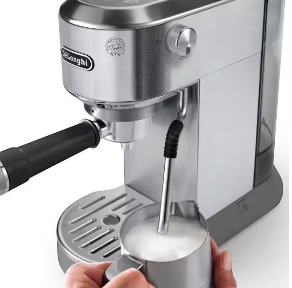 Taghareed De'Longhi Dedica Duo stainless steel espresso machine with advanced steam wand frothing milk.