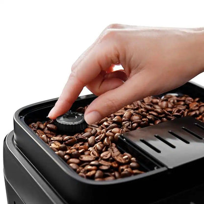 Taghareed De'Longhi Magnifica Evo coffee machine with grinder adjustment dial and coffee beans.