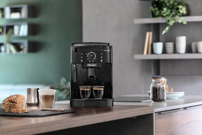 Taghareed De'Longhi Magnifica S compact black automatic coffee machine with built-in grinder and steam wand, brewing two espressos.