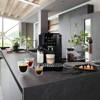 Taghareed De'Longhi Magnifica Start automatic coffee machine with LatteCrema Hot system, black, making a cappuccino.