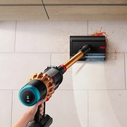 Taghareed Dyson V16 Piston Animal Submarine cordless vacuum in copper and black, cleaning spills on a tiled wall.