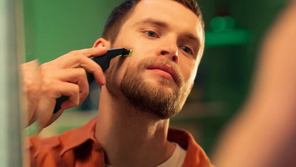 Taghareed Philips OneBlade Pro QP6542/10 electric trimmer for face and body grooming, black with yellow accents.