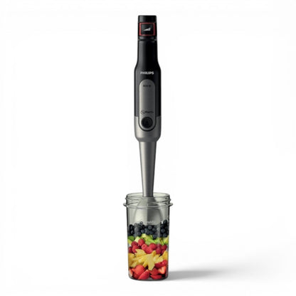 Taghareed Philips Viva Collection ProMix hand blender with 800W motor, SpeedTouch control, and anti-splash guard, shown with fruit in a beaker.