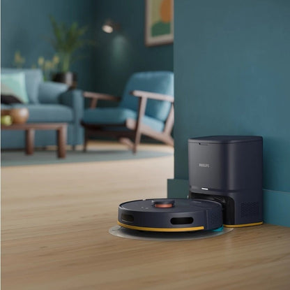 Taghareed Philips 2000 Series robot vacuum cleaner with auto-empty station, dark blue and yellow accents, cleans hardwood floors.