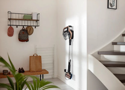Taghareed Philips SpeedPro Max stick vacuum cleaner in rose gold and black, mounted on wall charger. Features 360° nozzle and digital display.